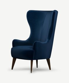 an upholstered blue chair with wooden legs and arm rests on a white background