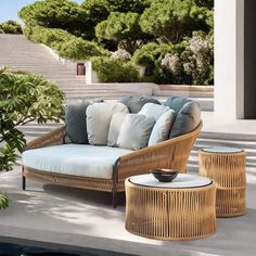 a wicker couch and two tables on a patio