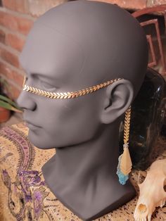 A magical allure meets mystic elegance with this beautiful Face Chain. Hand-crafted with meticulous love, this piece marries golden strands with a stunning copper blue patina feather, embodying the ancient dance of alchemy and elegance. Hand-Crafted: Each piece woven with intention and ritual. Affordable Elegance: A treasure trove of mystical charm without a high price. Versatile: A divine addition to any ceremonial attire, masquerade, or everyday enchantment Alchemy of Creation: Infused with love and crafted by hand, this face chain is not just an accessory; it's an affordable talisman of elegance, a whispered secret of ancient alchemy, making everyday a radiant. I hope you enjoy+ Mystical Metal Necklace For Festivals, Face Chain Jewelry, Mystical Brass Dangle Jewelry, Bohemian Metal Chain Body Jewelry, Gold Brass Fantasy Necklaces, Bohemian Gold Metal Body Chain, Mystical Jewelry, Face Necklace, Skull Face