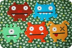 four different colored monsters on a green background