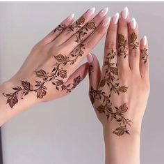 two hands with hendi tattoos on their palms and one holding the other's hand