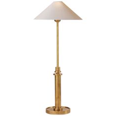 a gold lamp with a white shade on it