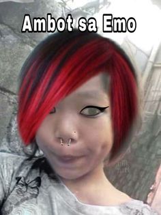 a girl with red hair and piercings has an emo look on her face