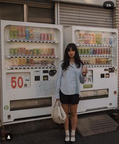 a woman standing in front of a vending machine