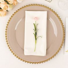 a place setting with flowers and napkins