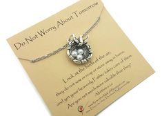 a card with a necklace on it that says do not worry about tomorrow, and an image of a crab