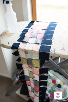 an ironing board covered in patchwork fabric