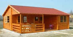 a small wooden cabin with a porch and balcony