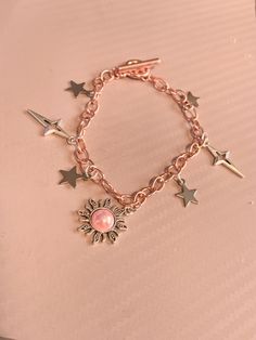 🌸 This beautiful bracelet was thrown together with inspiration from the sun and the stars but mixed with a pink, rose gold theme. They're a perfect gift for yourself or a gift to someone special! This bracelet is a tad above 7 in. 🌸 Lightweight and comfortable. The bracelet's chain is stainless steel plated with rose gold and the charms are stainless steel at well with a pretty pink gemstone on the sun. If you have any questions please feel free to reach out 🌸 -DakotasJoy Sun Bracelet, Gold Arm Band, Rose Gold Theme, Bracelet Star, Bracelet Rose Gold, Rose Gold Charms, Gold Theme, Gold Armband, Gold Sun