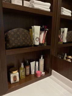 the shelves in the bathroom are filled with toiletries and personal care items, including handbags