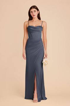 a bridesmaid in a grey dress with a slited skirt and spaghetti straps