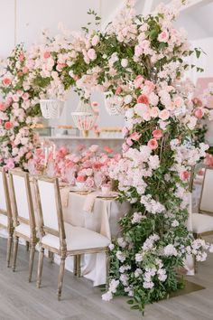 the table is set with pink and white flowers