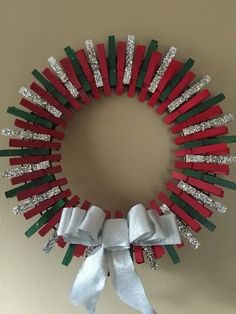 a christmas wreath made out of red, green and white candy sticks with silver sequins