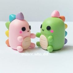 two small toy animals sitting next to each other