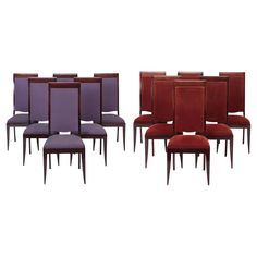 a set of six dining chairs with purple upholstered backrests and wooden legs