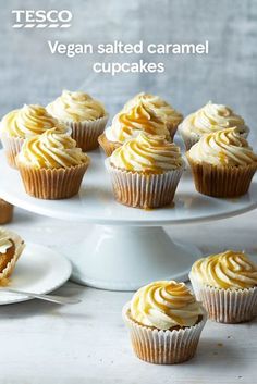 several cupcakes are sitting on a cake platter with the words vegan salted caramel cupcakes