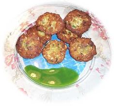 some fried food on a plate with green sauce