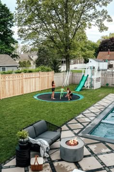 a backyard with a fire pit and children's play area