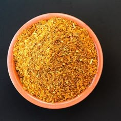 a bowl filled with some kind of yellow colored substance on top of a black table