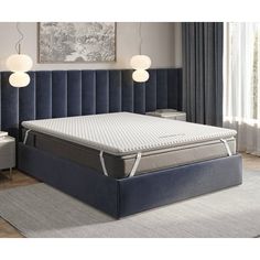 an image of a mattress in the middle of a room with two lamps on either side