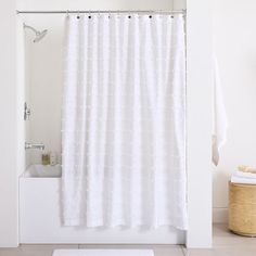 a white shower curtain in a bathroom