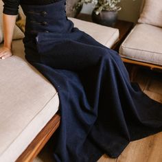 Elevate your winter wardrobe with our High Waisted Wool Maxi Skirt, crafted from luxurious cool wool for a sophisticated touch. This timeless piece features an extra-high waist adorned with stylish buttons, convenient pockets for added functionality, and a floor-length silhouette that effortlessly combines comfort and elegance, making it a versatile addition to any fashion-forward ensemble.  Enjoy the effortless fit and the feminine sense when wearing our creations! Every piece by NikkaPlace is Stylish Buttons, Wool Maxi Skirt, Empire Waist Maxi, Elegant Coats, High Waisted Maxi Skirt, Skirt With Buttons, Tie Skirt, Fantasy Gowns, Full Circle Skirts