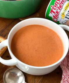 a bowl of soup next to some bread