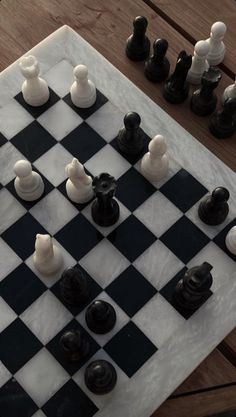 a chess board with black and white pieces on it