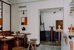 an empty restaurant with tables and stools