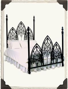 a black iron bed with white sheets and pillows