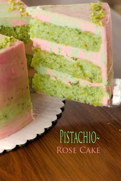 there is a cake with pink and green frosting on the top that has been cut in half