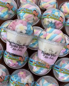 several cups filled with marshmallows sitting on top of each other in plastic containers