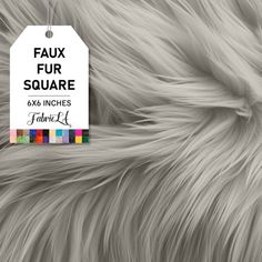 the label is attached to a furry animal's fur textured with multicolored squares