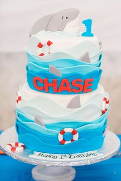 a three tiered cake decorated with blue, white and red frosting that says chase