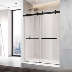 a white bathroom with a glass shower door and black handlebars on the wall