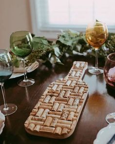 a wooden table topped with wine glasses and a keyboard