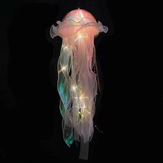 a light up jellyfish floating in the dark