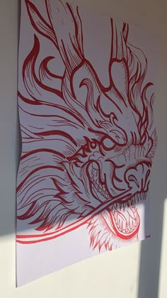 a drawing of a dragon on the side of a building with red paint and white paper