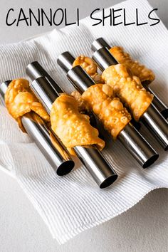 four pieces of cannoli shells sitting on top of a white napkin with the words cannoli shells