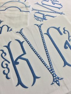 the table cloth has been decorated with blue monogrammed letters