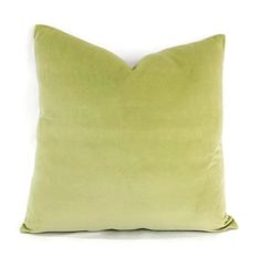 a lime green pillow on a white background