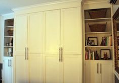 a large white bookcase in the corner of a room