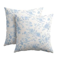 two blue and white floral pillows on a white background, one is made out of linen