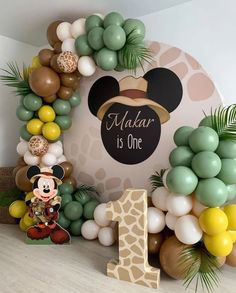 a mickey mouse birthday party with balloons and decorations