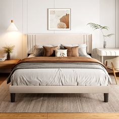 a bedroom with white walls and wooden floors