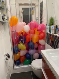 a bathroom with balloons all over the floor