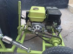 a small green engine sitting on top of a trailer