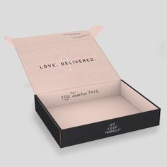 an open box that says love delivered on the inside, and it is black with white lettering