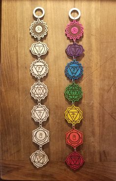 seven chakras hanging on a wooden wall