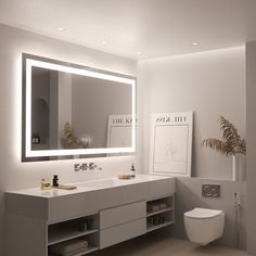 a bathroom with a sink, toilet and large mirror above the vanity is illuminated by lights